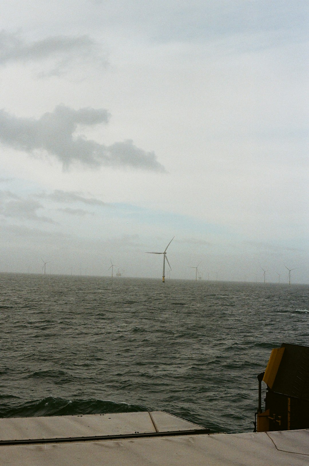 wind-turbines-in-the-ocean-under-a-cloudy-sky-lv8om9g9g0